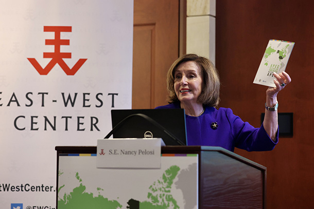 Speaker Emerita Nancy Pelosi speaking at a podium at the APEC Matters launch event