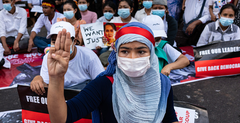 An anti-coup protester raises the opposition's three-fingered salute in Myanmar. Photo: Hkun Lat/Getty Images