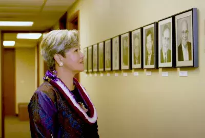 EWC President Suzanne Vares-Lum with the portraits of past EWC presidents
