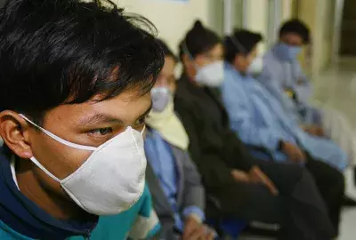  Vietnamese family members wait for news of their relatives hospitalized with a respiratory illness similar to the Bird Influenza (also called Avian Flu) at the Bach Mai hospital, National Institute of Infectious and Tropical Diseases January 22, 2004 in Hanoi, Vietnam.