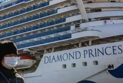 Individual standing in front of Diamond Princess cruise ship