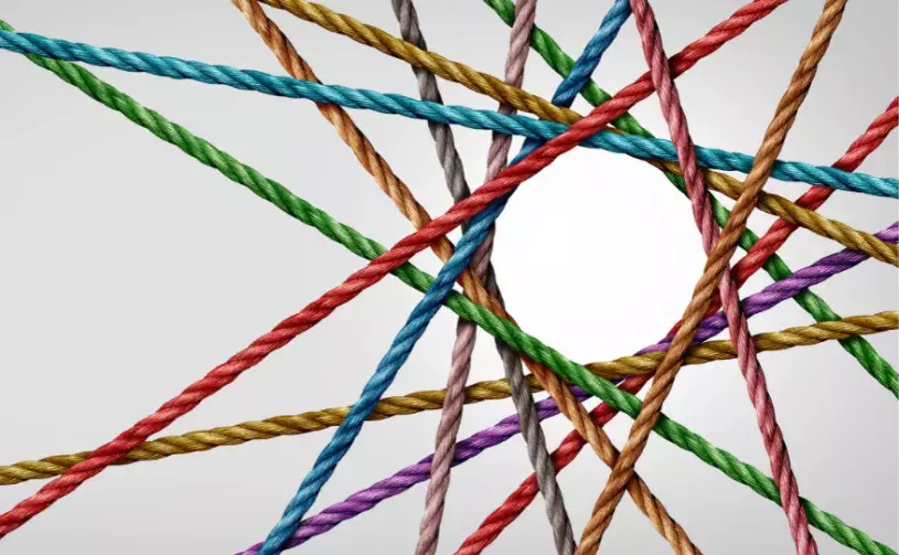 Multicolored overlapping threads in a geometric pattern.