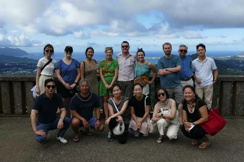 Members of the 2022 KUSJE pose for a photo at the Nuʻuanu Pali Overlook on Oʻahu, Hawaiʻi.