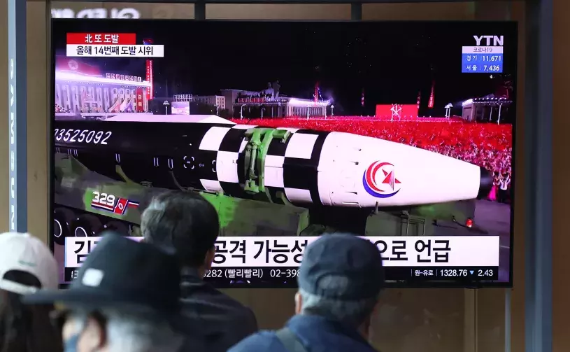 South Koreans watch a 2022 North Korean missile parade on TV